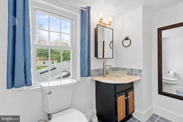 522 Creek Rd, Moorestown, NJ 08057 - bathroom featuring toilet, vanity, tile patterned floors, decorative backsplash, and baseboards