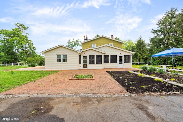 522 Creek Rd, Moorestown, NJ 08057 - back of property with a sunroom, a chimney, a patio area, and fence