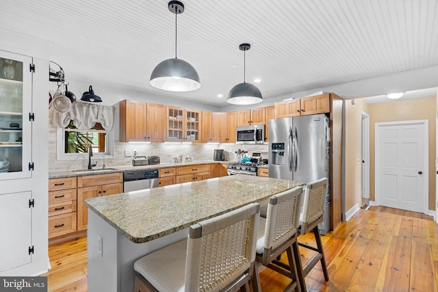 522 Creek Rd, Moorestown, NJ 08057 - kitchen featuring appliances with stainless steel finishes, a sink, light wood finished floors, glass insert cabinets, and backsplash