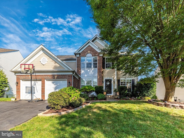 4 Jeffrey Ln, Brunswick, MD 21758 - view of front of property featuring brick siding, asphalt driveway, a front lawn, and an attached garage