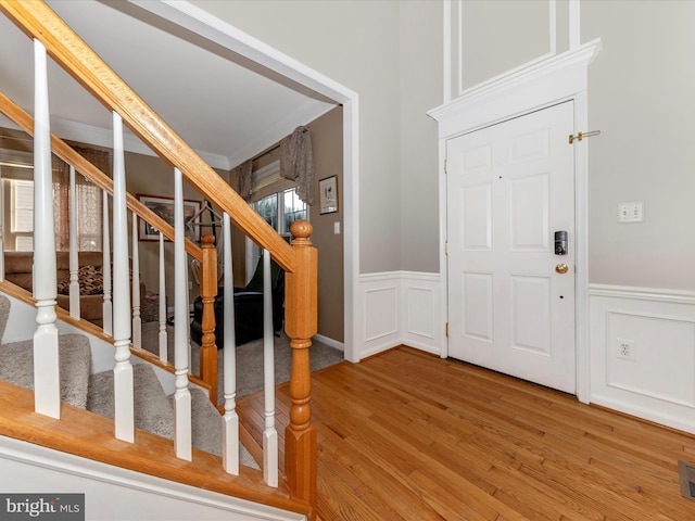 4 Jeffrey Ln, Brunswick, MD 21758 - entrance foyer featuring wood finished floors, a wainscoted wall, a decorative wall, and stairway