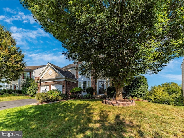 4 Jeffrey Ln, Brunswick, MD 21758 - view of front of home featuring brick siding, a front lawn, an attached garage, and asphalt driveway