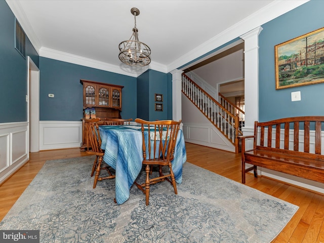 4 Jeffrey Ln, Brunswick, MD 21758 - dining area with decorative columns, wood finished floors, crown molding, a chandelier, and a decorative wall