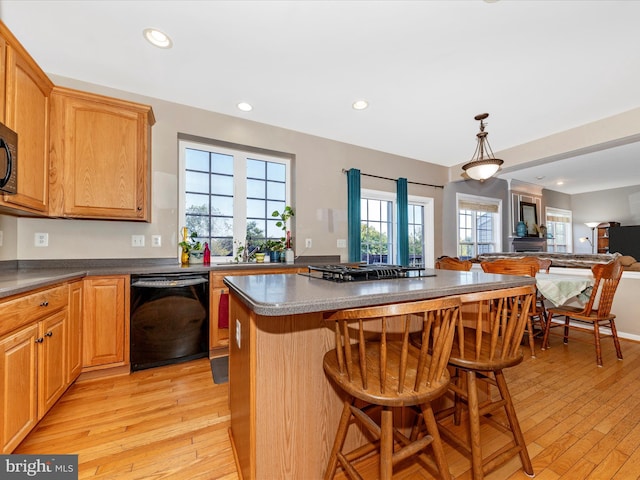 4 Jeffrey Ln, Brunswick, MD 21758 - kitchen with black appliances, open floor plan, light wood finished floors, a kitchen bar, and a center island