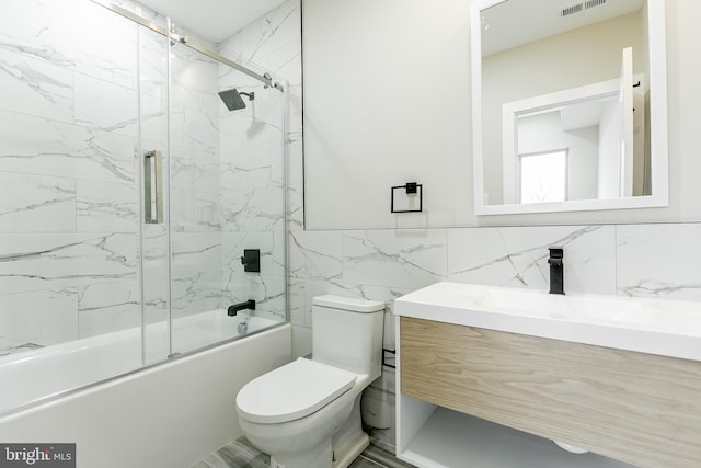 3221 Mercer St, Philadelphia, PA 19134 - full bath featuring tile walls, toilet, vanity, and enclosed tub / shower combo