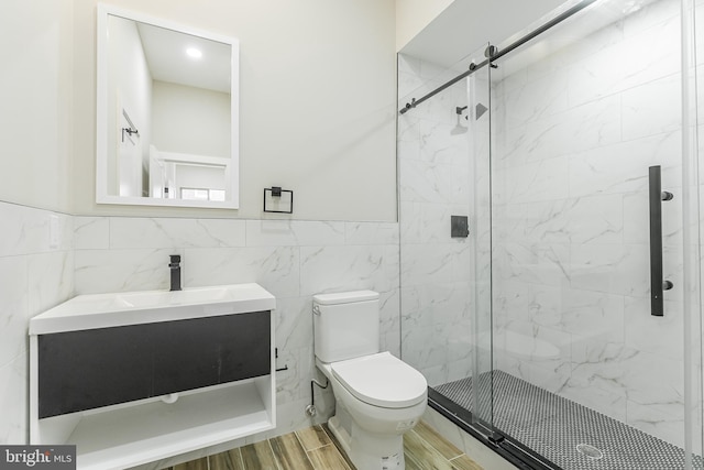 3221 Mercer St, Philadelphia, PA 19134 - full bathroom with tile walls, toilet, a marble finish shower, vanity, and wainscoting