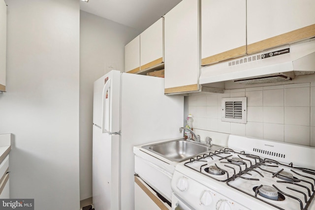 1111 Arlington Blvd Unit 810, Arlington, VA 22209 - kitchen with white appliances, under cabinet range hood, decorative backsplash, white cabinetry, and light countertops