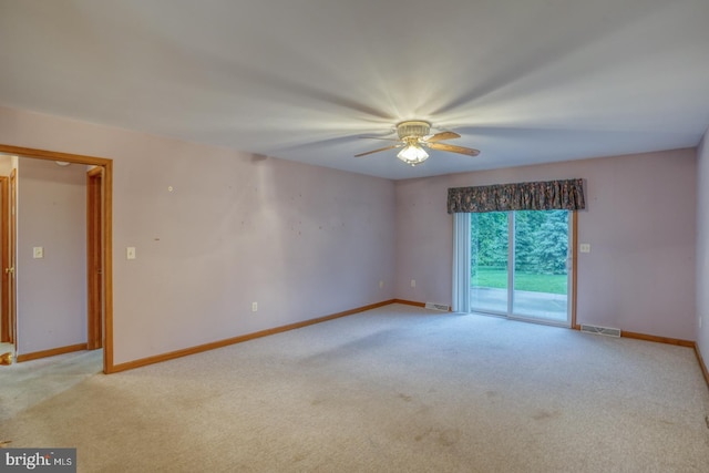 74 Connie Ln, Dover, DE 19901 - spare room featuring light carpet, ceiling fan, and baseboards
