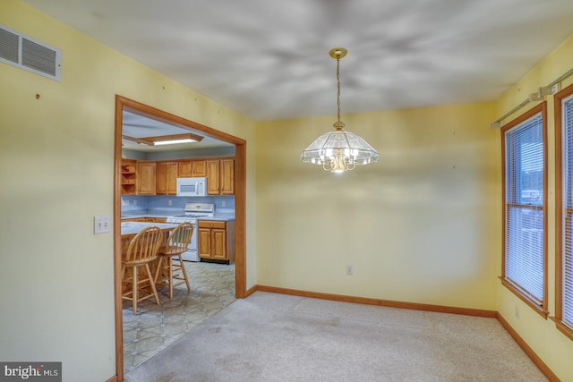 74 Connie Ln, Dover, DE 19901 - dining area with a chandelier, baseboards, and light colored carpet