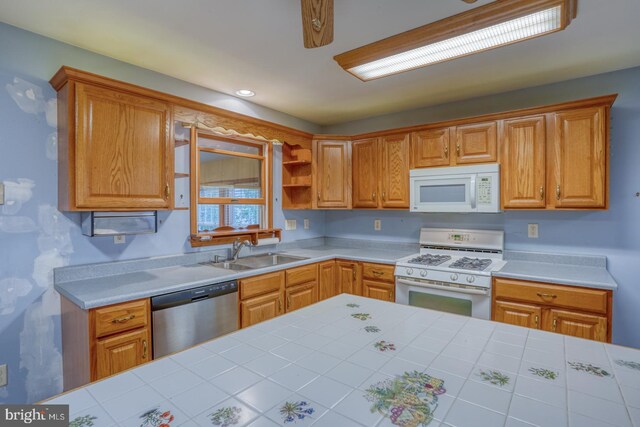 74 Connie Ln, Dover, DE 19901 - kitchen featuring white appliances, a sink, and brown cabinetry