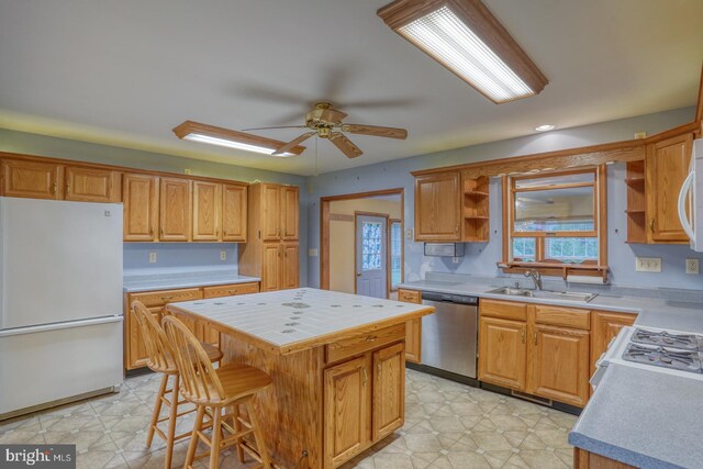 74 Connie Ln, Dover, DE 19901 - kitchen with white appliances, open shelves, a sink, a center island, and a ceiling fan