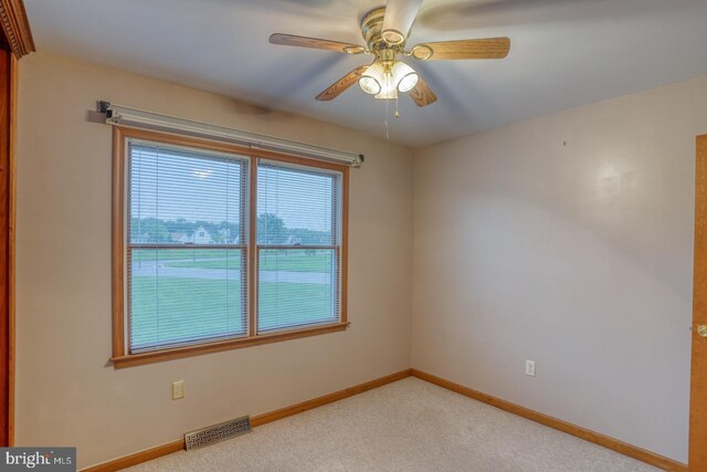 74 Connie Ln, Dover, DE 19901 - unfurnished room with plenty of natural light, a ceiling fan, light colored carpet, and baseboards