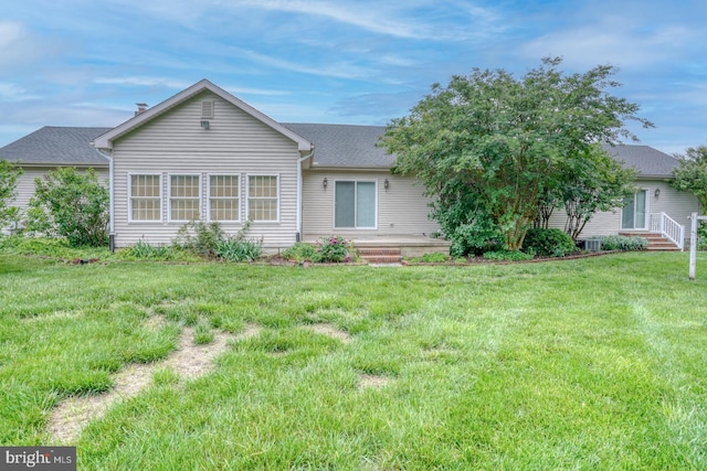 74 Connie Ln, Dover, DE 19901 - rear view of house featuring a lawn and roof with shingles