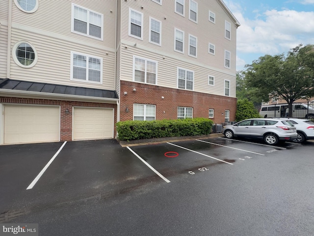 9713 Handerson Pl Unit 104, Manassas Park, VA 20111 - view of building exterior featuring uncovered parking