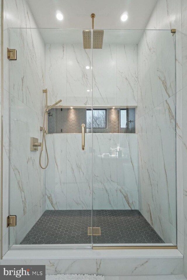 full bathroom featuring a marble finish shower and recessed lighting