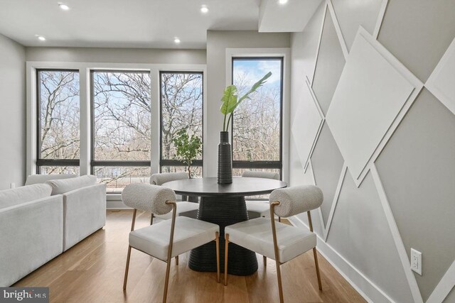 dining space featuring wood finished floors and recessed lighting