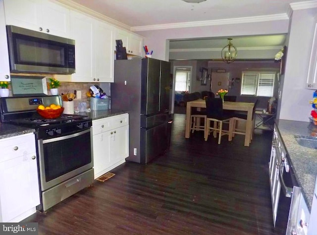 3016 Pennsylvania Ave, Lansdowne, MD 21227 - kitchen with stainless steel appliances, ornamental molding, white cabinets, dark wood finished floors, and tasteful backsplash