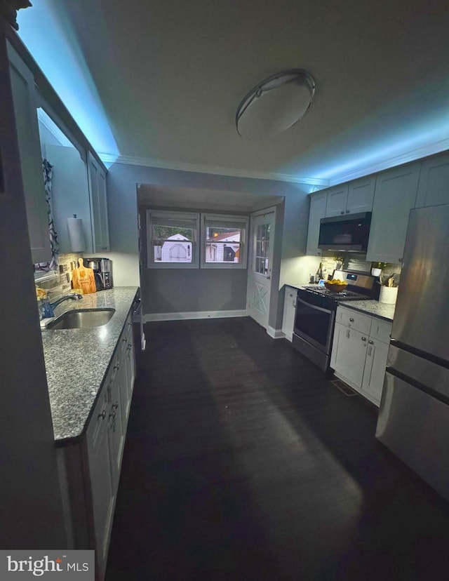 3016 Pennsylvania Ave, Lansdowne, MD 21227 - kitchen featuring stainless steel appliances, a sink, baseboards, backsplash, and light stone countertops