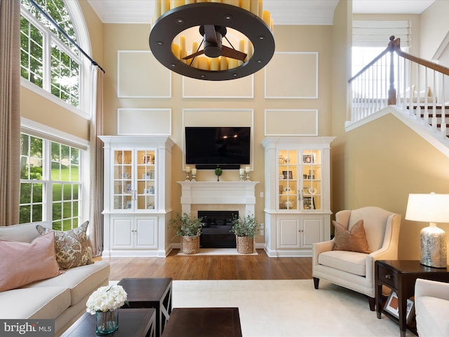 130 Waterfall Ln, Landenberg, PA 19350 - living room featuring a towering ceiling, wood finished floors, a fireplace with flush hearth, and stairway