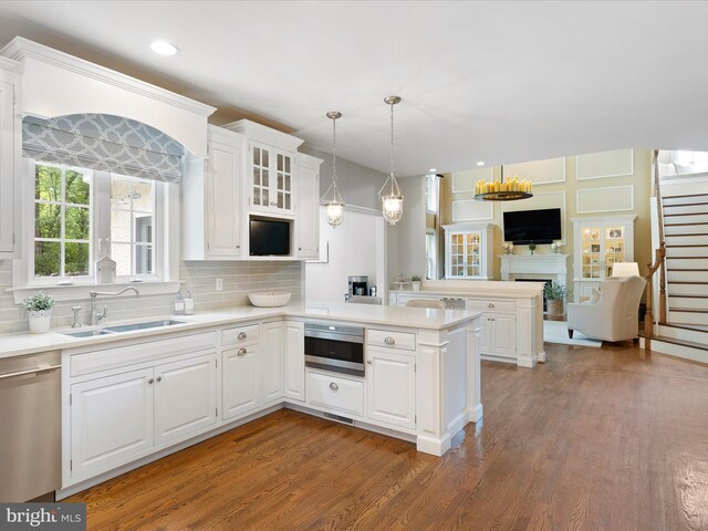 130 Waterfall Ln, Landenberg, PA 19350 - kitchen featuring a sink, stainless steel appliances, a peninsula, a fireplace, and light countertops