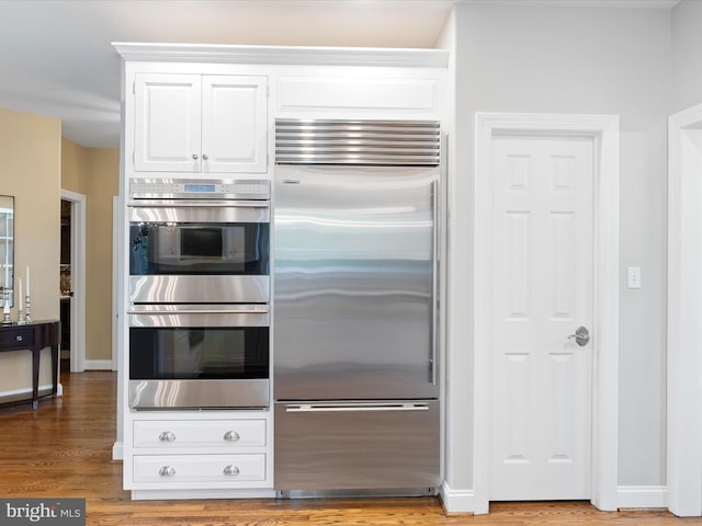 130 Waterfall Ln, Landenberg, PA 19350 - kitchen with stainless steel appliances, white cabinetry, wood finished floors, and baseboards
