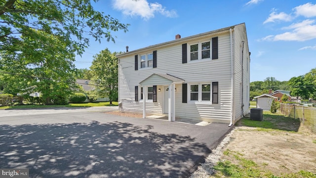 8014 Ritchie Hwy, Pasadena, MD 21122 - view of front of house with central air condition unit, driveway, and a chimney
