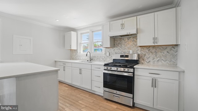 8014 Ritchie Hwy, Pasadena, MD 21122 - kitchen with gas range, under cabinet range hood, a sink, light countertops, and crown molding