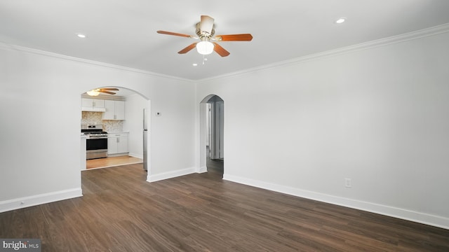 8014 Ritchie Hwy, Pasadena, MD 21122 - unfurnished living room featuring a ceiling fan, arched walkways, crown molding, dark wood-style flooring, and baseboards
