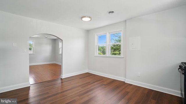 8014 Ritchie Hwy, Pasadena, MD 21122 - unfurnished room featuring arched walkways, wood finished floors, and baseboards