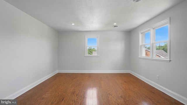 8014 Ritchie Hwy, Pasadena, MD 21122 - unfurnished room featuring healthy amount of natural light, baseboards, wood finished floors, and recessed lighting
