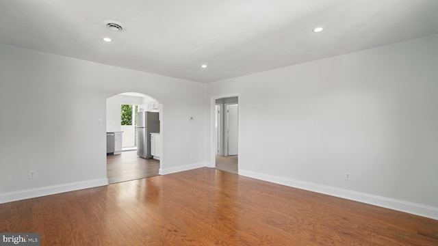 8014 Ritchie Hwy, Pasadena, MD 21122 - spare room featuring arched walkways, wood finished floors, baseboards, and recessed lighting