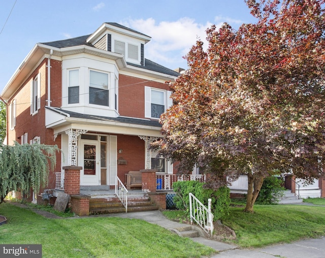 408 Frederick St, Hanover, PA 17331 - view of front of home featuring brick siding, a porch, and a front yard