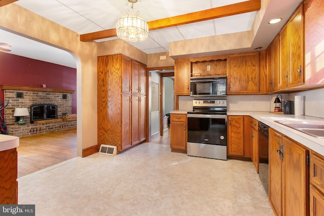 408 Frederick St, Hanover, PA 17331 - kitchen with black appliances, light floors, light countertops, and brown cabinetry