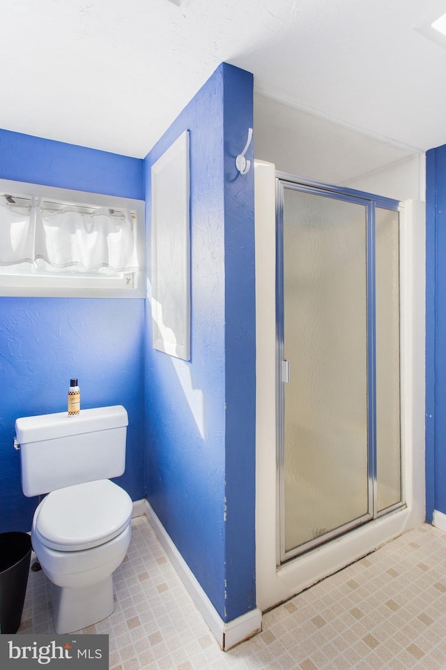 408 Frederick St, Hanover, PA 17331 - bathroom featuring baseboards, a stall shower, and toilet