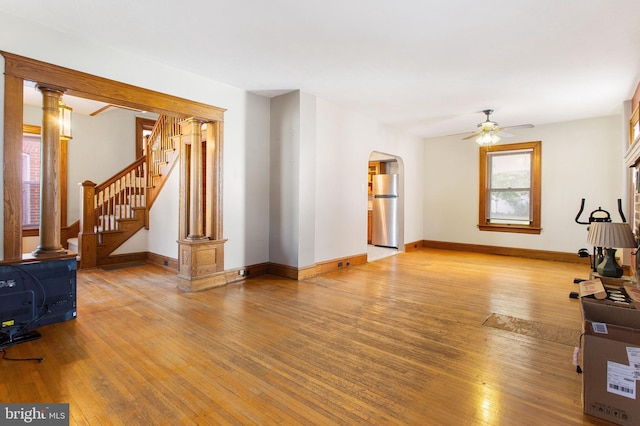 408 Frederick St, Hanover, PA 17331 - unfurnished living room with hardwood / wood-style floors, ceiling fan, arched walkways, baseboards, and stairs