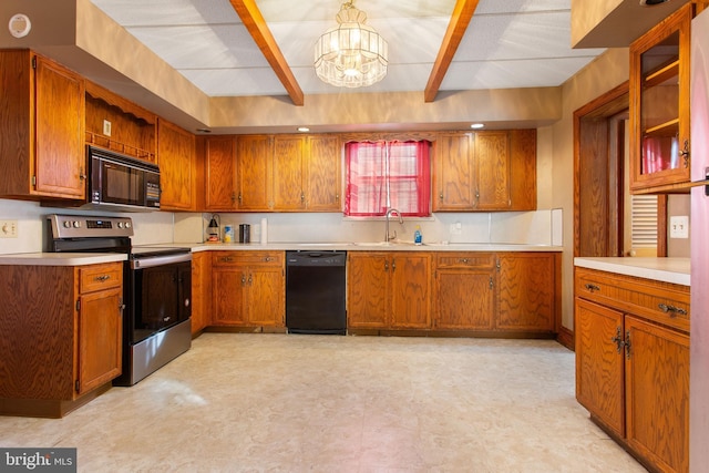 408 Frederick St, Hanover, PA 17331 - kitchen featuring black appliances, light flooring, a chandelier, a sink, and brown cabinetry