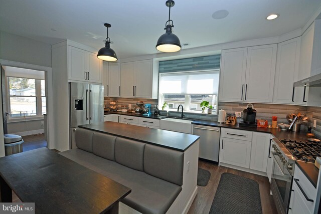 7012 Silverwood St, Philadelphia, PA 19128 - kitchen featuring stainless steel appliances, a sink, dark countertops, healthy amount of natural light, and recessed lighting