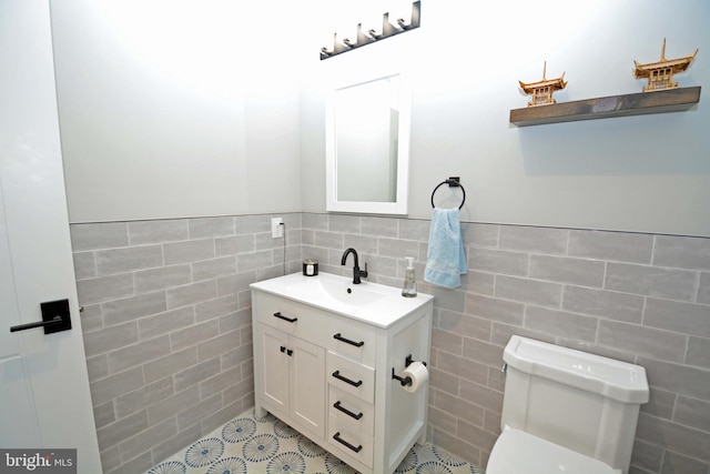 7012 Silverwood St, Philadelphia, PA 19128 - bathroom with tile walls, toilet, vanity, and tile patterned flooring