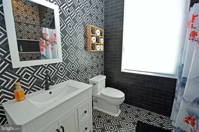 7012 Silverwood St, Philadelphia, PA 19128 - bathroom with toilet, tiled shower, vanity, and tile walls