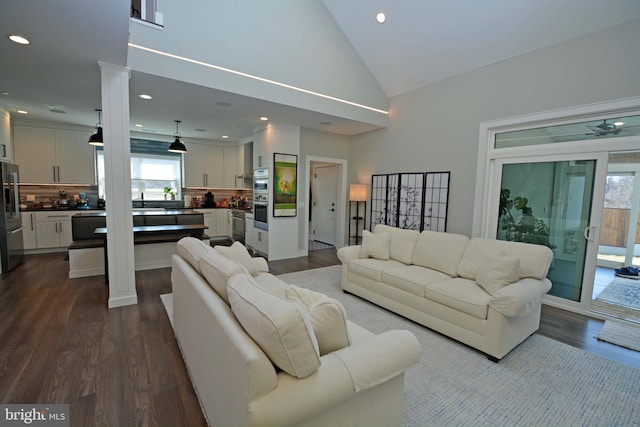 7012 Silverwood St, Philadelphia, PA 19128 - living area featuring dark wood-type flooring, healthy amount of natural light, decorative columns, recessed lighting, and ceiling fan