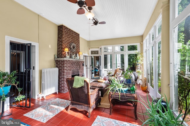 sunroom / solarium featuring radiator, french doors, and tile patterned floors