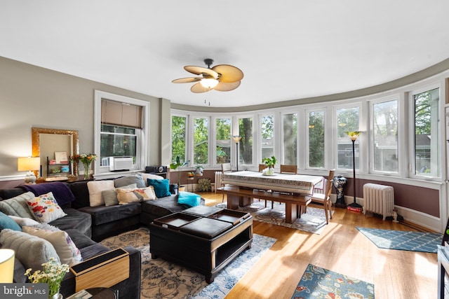 sunroom / solarium with radiator and wood finished floors