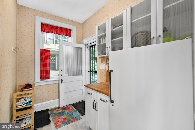 mudroom featuring wallpapered walls