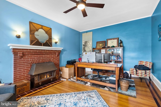 home office featuring wood finished floors, ceiling fan, and crown molding