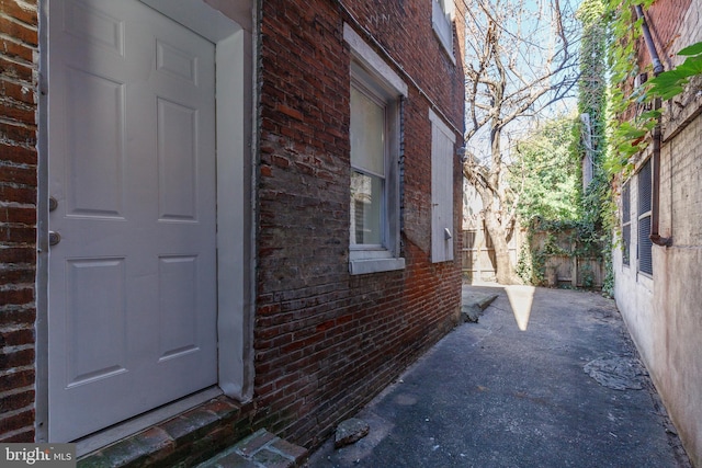 110 W Hamburg St, Baltimore, MD 21230 - view of side of home featuring brick siding and fence