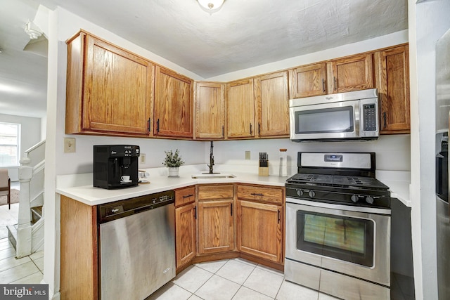 110 W Hamburg St, Baltimore, MD 21230 - kitchen featuring stainless steel appliances, light tile patterned flooring, a sink, and light countertops