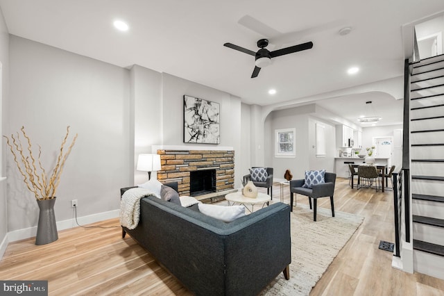 5113 W Thompson St, Philadelphia, PA 19131 - living area featuring arched walkways, ceiling fan, a fireplace, light wood-style floors, and recessed lighting