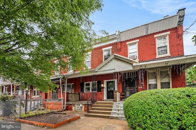5113 W Thompson St, Philadelphia, PA 19131 - view of front of property featuring a porch, brick siding, and fence