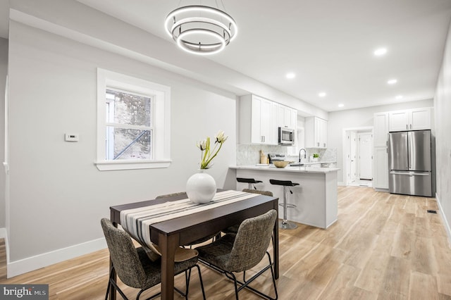 5113 W Thompson St, Philadelphia, PA 19131 - dining space featuring baseboards, light wood finished floors, and recessed lighting