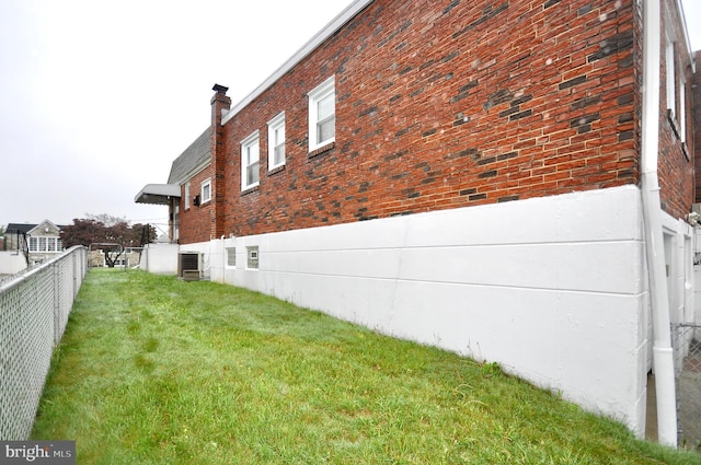 8922 Brous Ave, Philadelphia, PA 19152 - view of side of home featuring cooling unit, brick siding, and a chimney